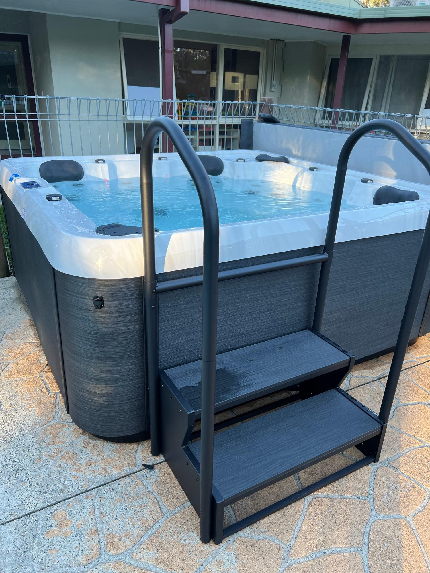 Outdoor hydrotherapy spa on the paved courtyard at Sanctuary House in Healesville