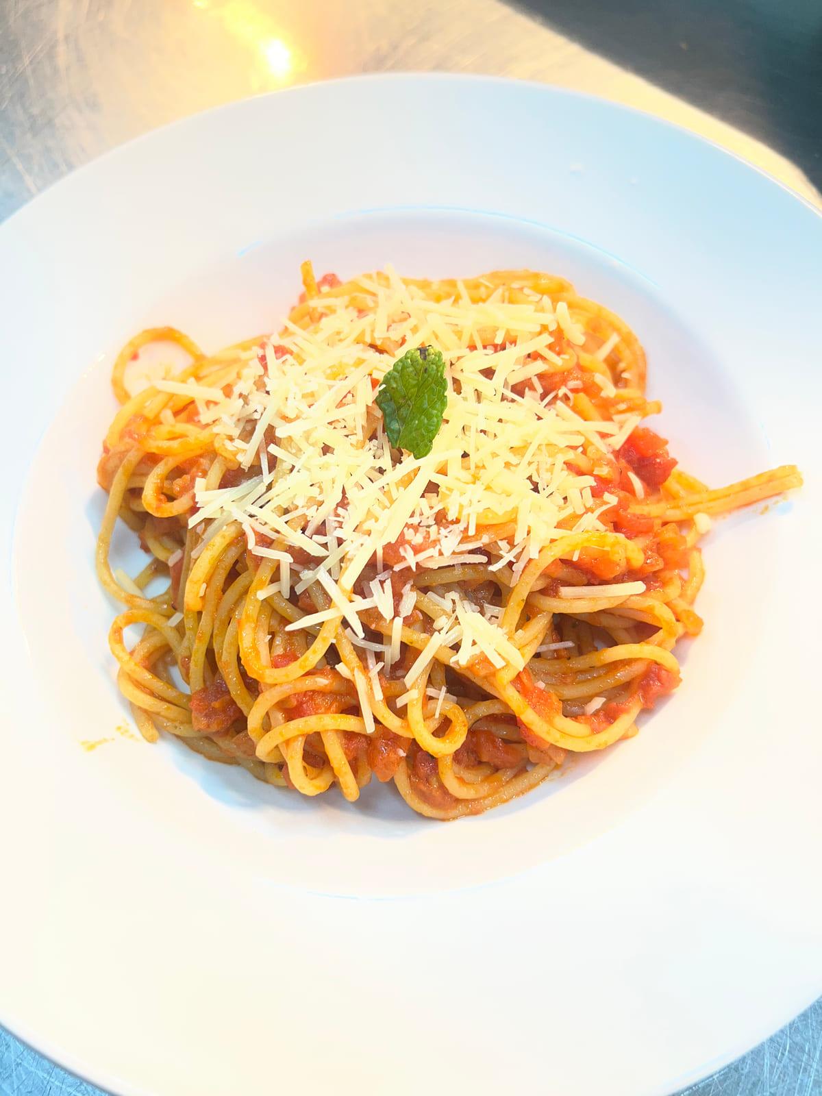 Pasta Polpette — spaghetti in rich tomato sauce topped with parmesan